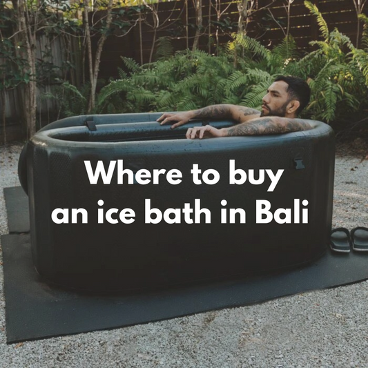 Man sitting in a black ice bath outdoors.