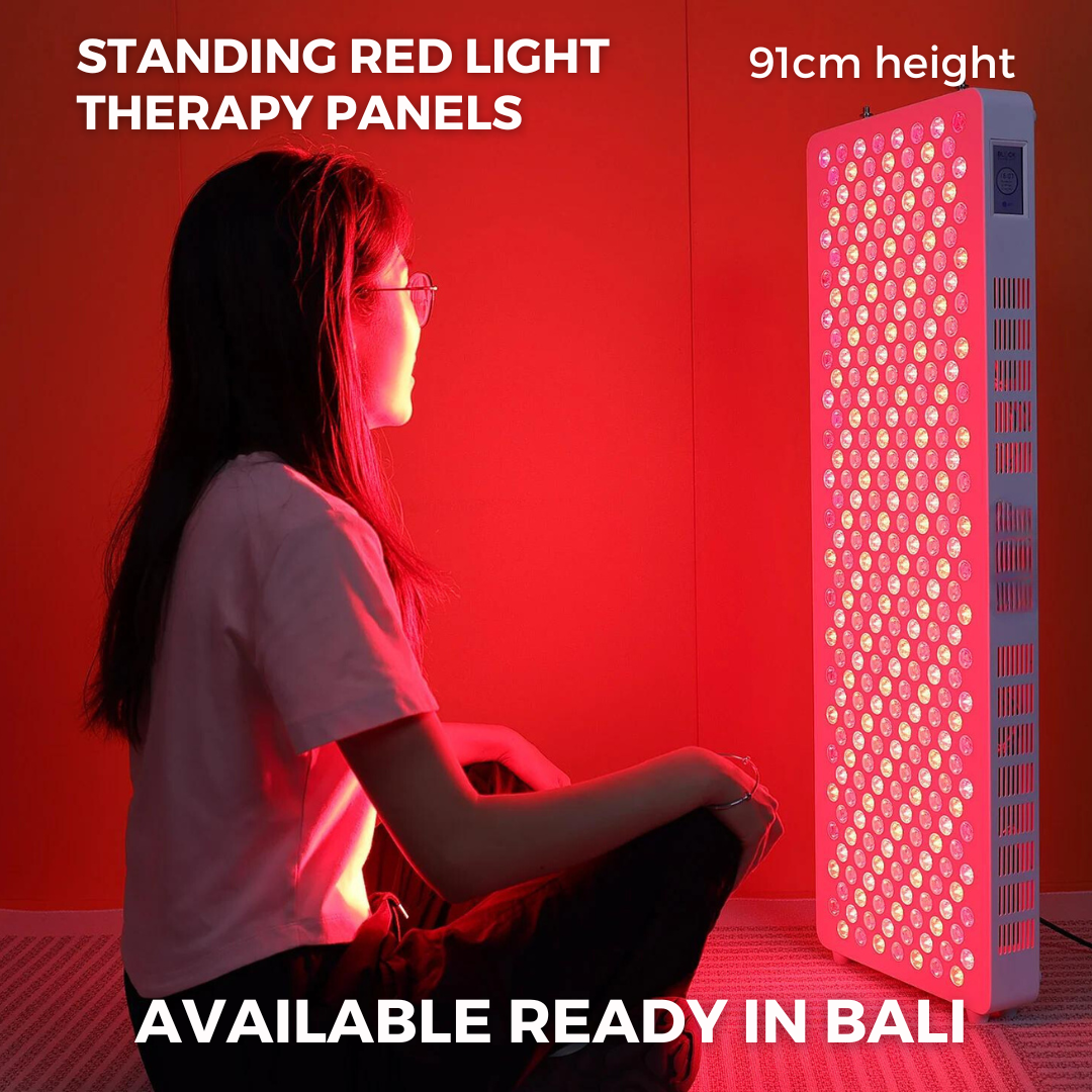 Woman sitting in front of red light therapy panel