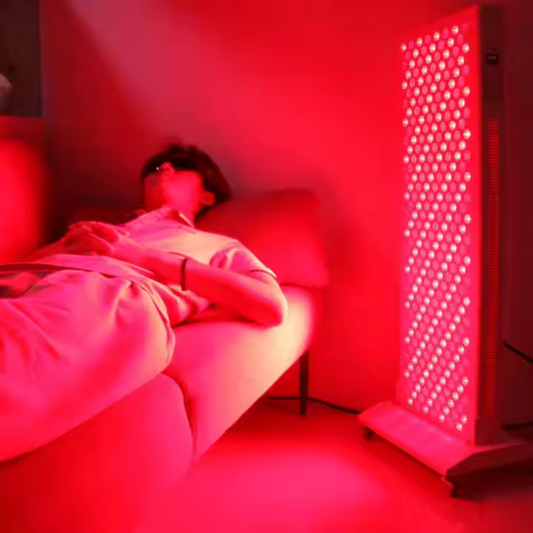 a woman laying infront on a red light therapy panel